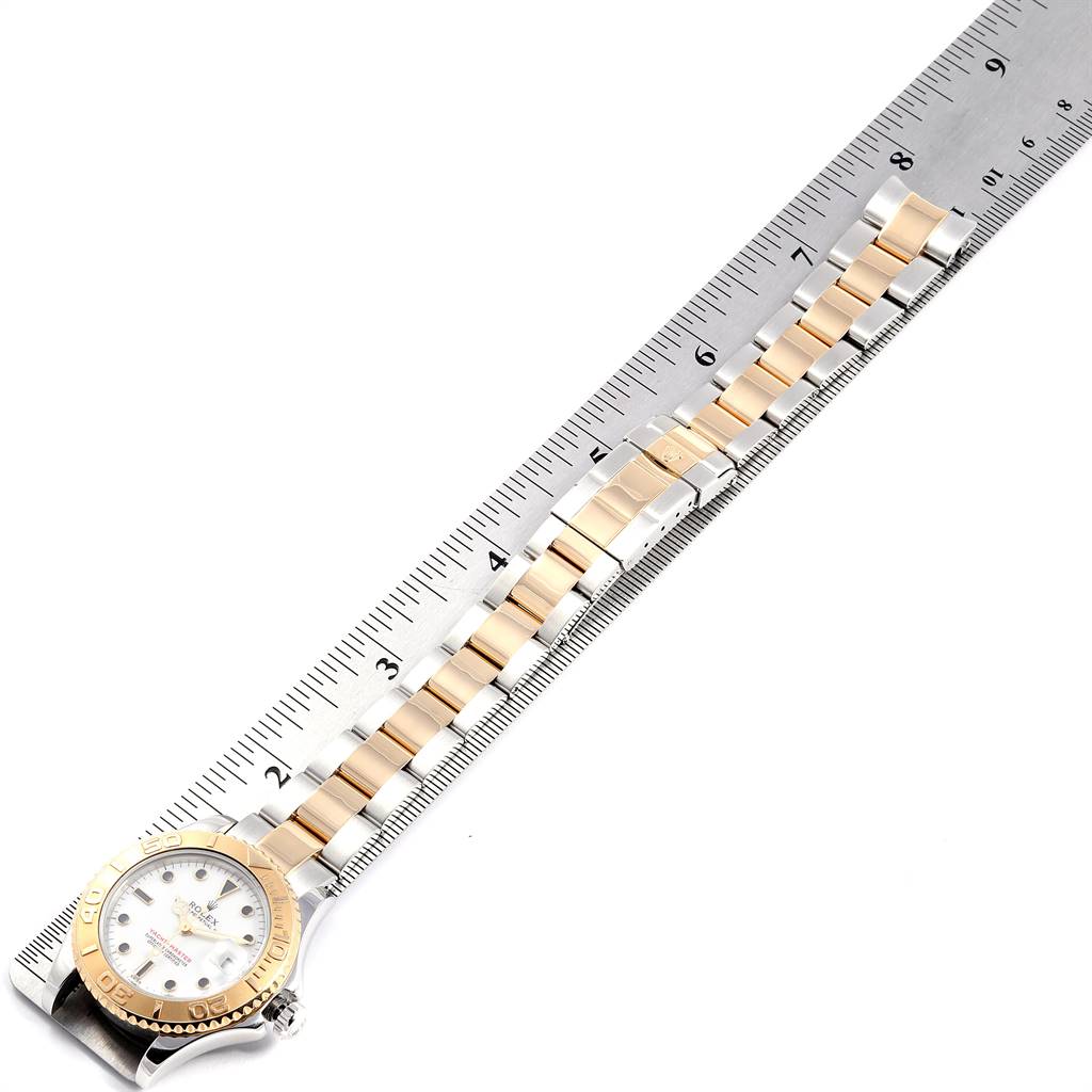 The Rolex Yacht-Master 68623 Men's Steel and Gold (two tone) White Dial 68623 Men's Steel and Gold (two tone) White Dial watch is shown lying flat with its face and entire bracelet visible, alongside a measuring ruler.