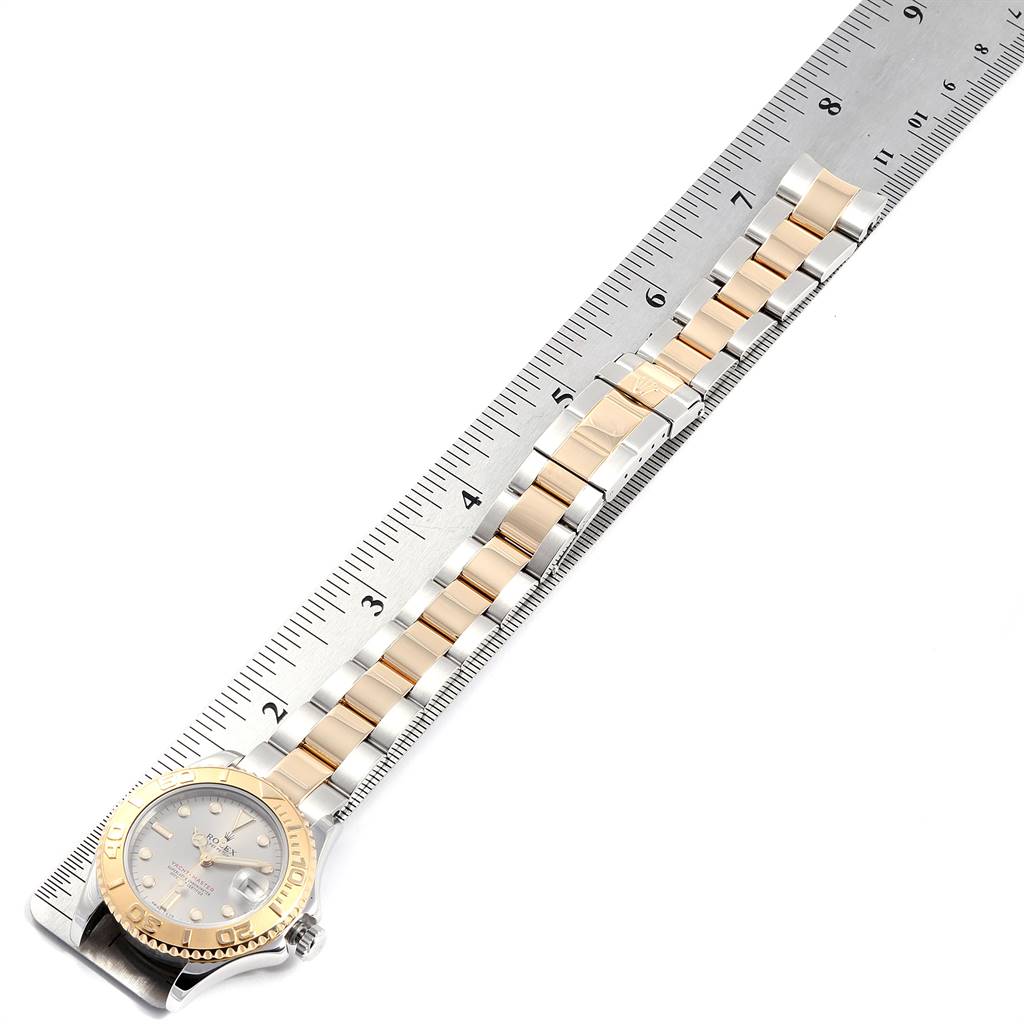 The image shows a Rolex Yacht-Master 68623 Men
s Steel and Gold (two tone) Grey Dial 68623 Men
s Steel and Gold (two tone) Grey Dial watch laid flat with its bracelet aligned along a ruler for measurement.