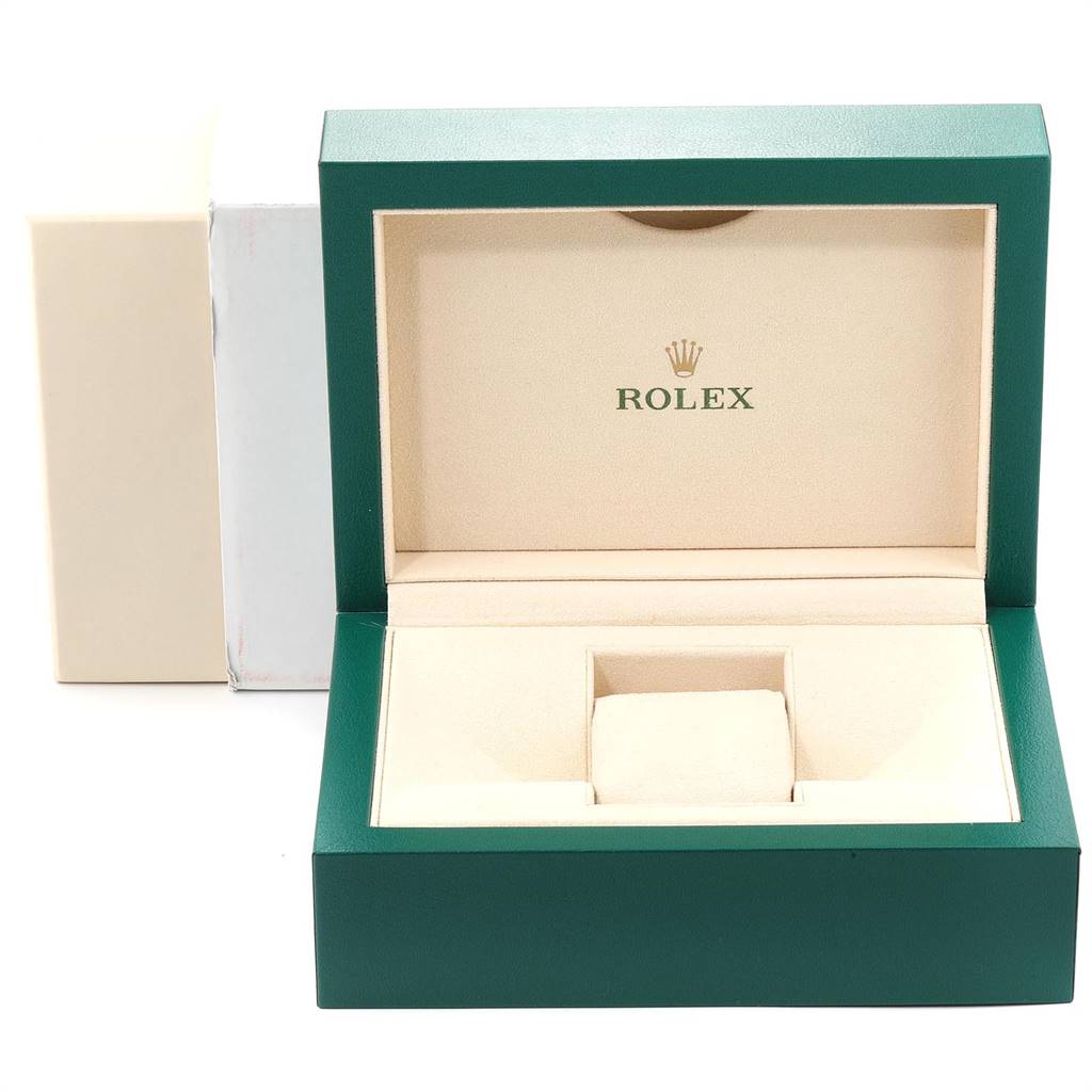 The image shows an open green and beige box with the logo and name of Rolex, typically used for the Yacht-Master model.