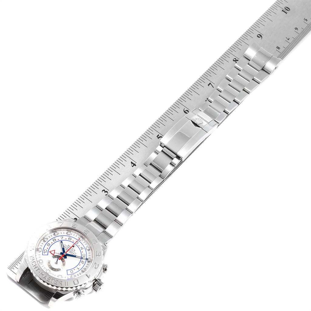 This image shows the Rolex Yacht-Master 116689 Men's White Gold White Dial 116689 Men's White Gold White Dial watch positioned diagonally, with focus on the bracelet and clasp against a measuring ruler.