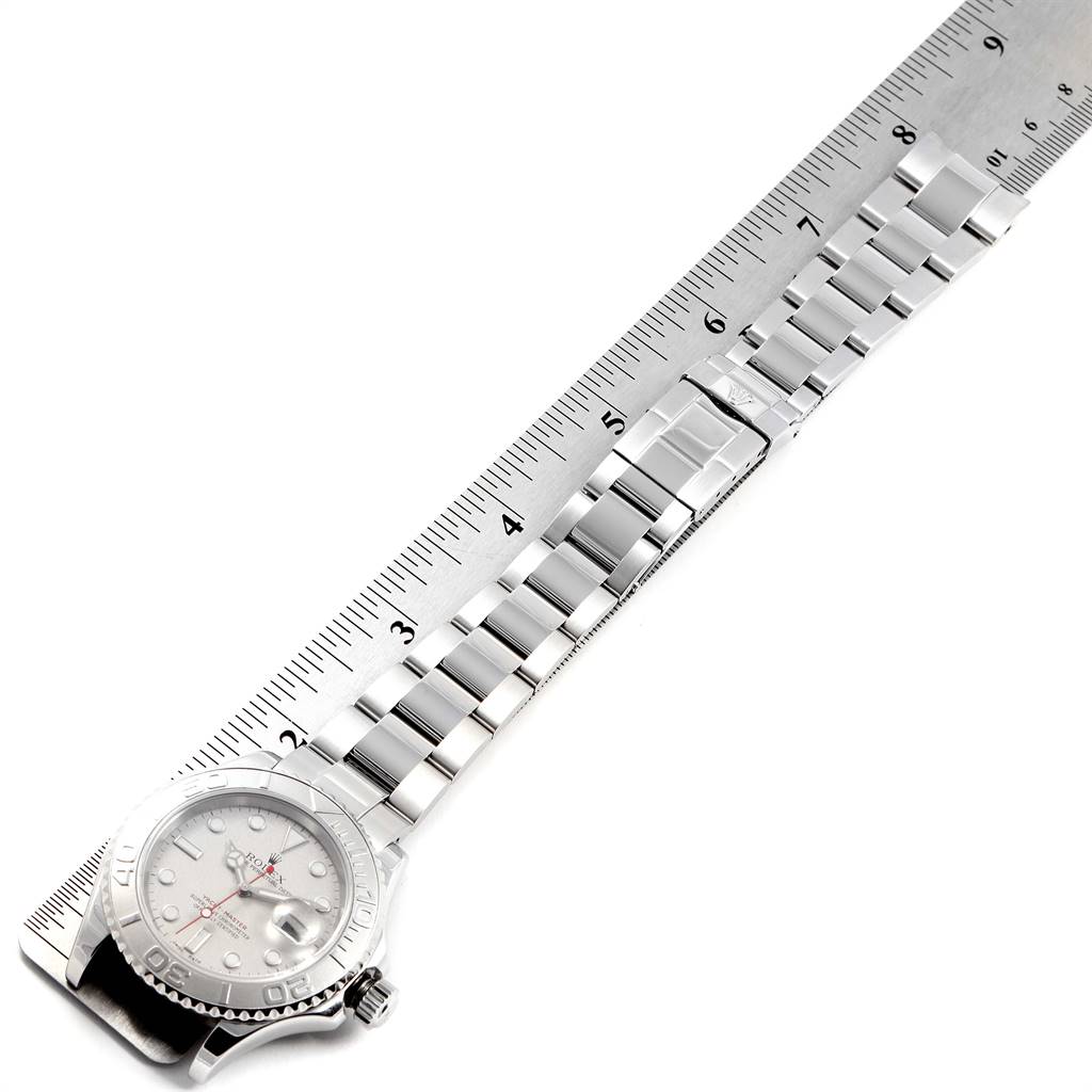 This image shows the Rolex Yacht-Master 16622 Men
s Stainless Steel Silver Dial 16622 Men
s Stainless Steel Silver Dial watch laid flat next to a ruler, displaying the watch face and band.