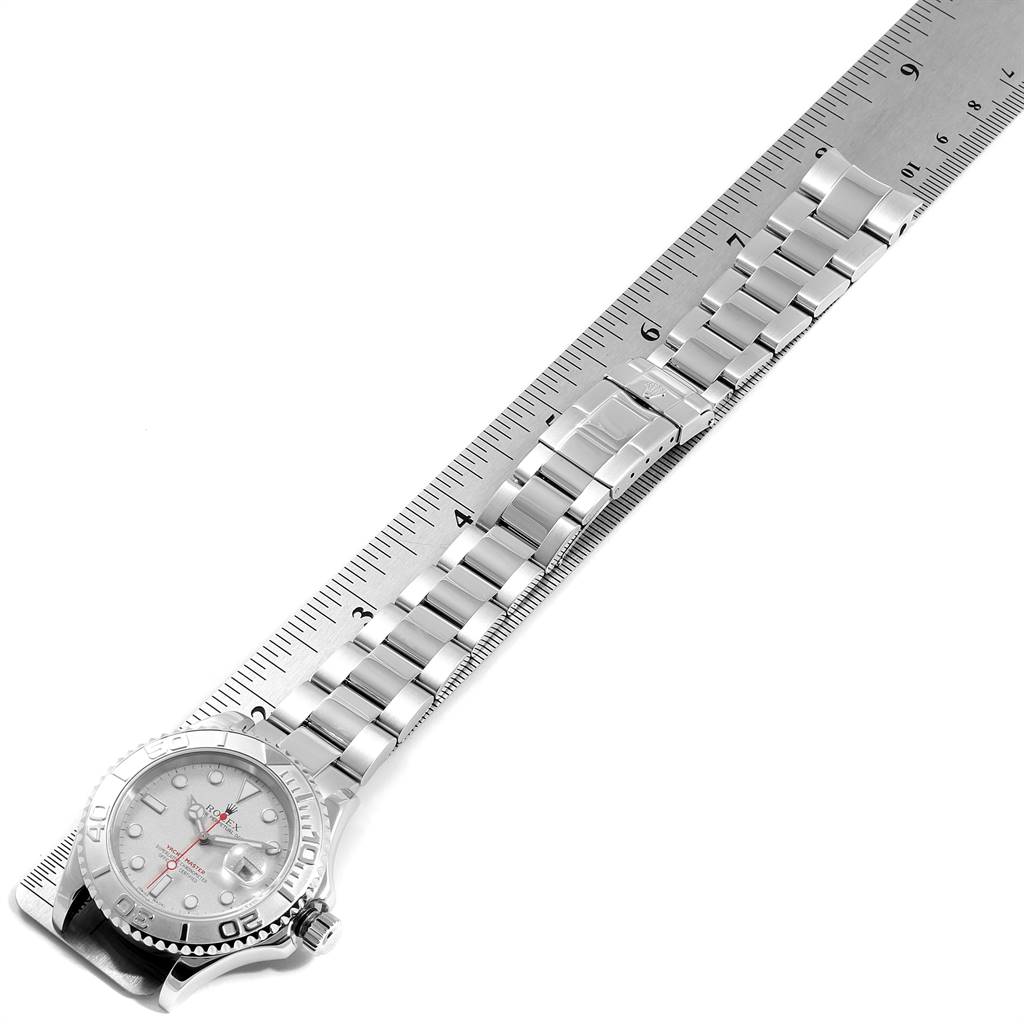 This image shows the Rolex Yacht-Master 16622 Men
s Stainless Steel Silver Dial 16622 Men
s Stainless Steel Silver Dial watch laid flat alongside a ruler, highlighting the bracelet and part of the dial.