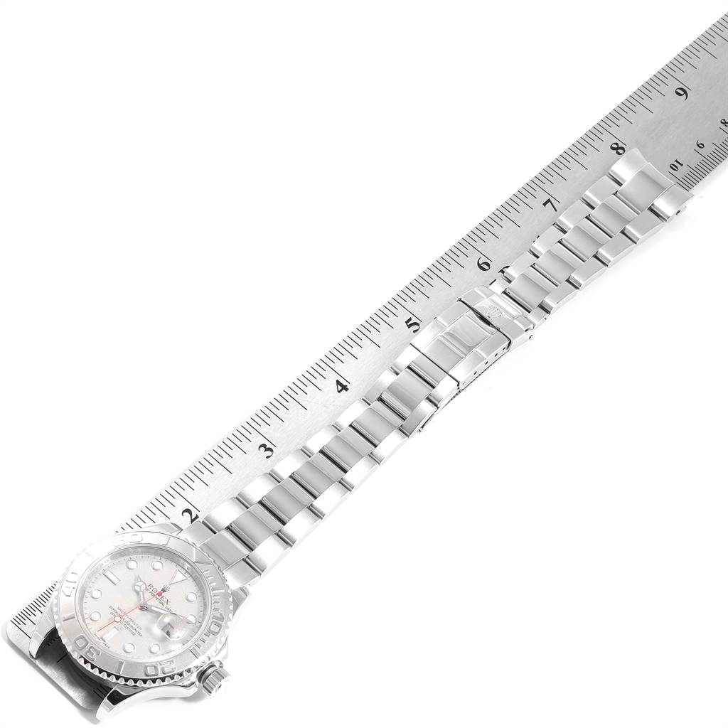 The Rolex Yacht-Master 16622 Men
s Stainless Steel Silver Dial 16622 Men
s Stainless Steel Silver Dial watch is shown from an overhead angle, featuring its bracelet and case against a ruler for scale.