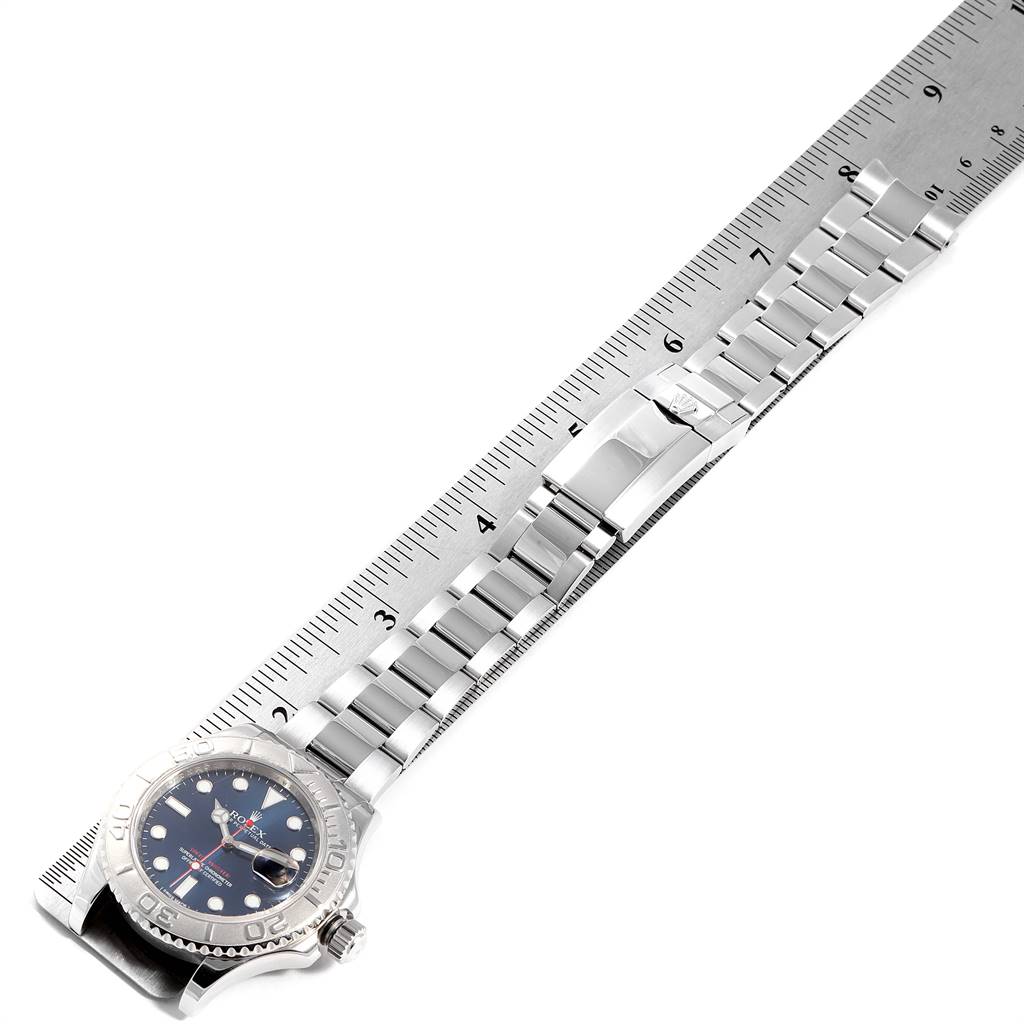 The image shows a Rolex Yacht-Master 116622 Men
s Stainless Steel Blue Dial 116622 Men
s Stainless Steel Blue Dial watch laid flat, showcasing the watch face, bezel, and full metal bracelet against a ruler.