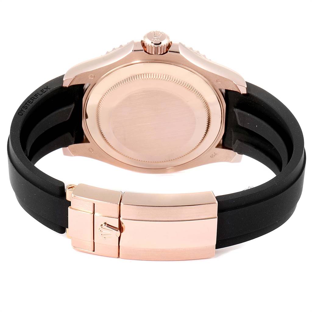 The image shows the back case, crown, and clasp of a Rolex Yacht-Master 116655 Men's Rose Gold Black Dial 116655 Men's Rose Gold Black Dial watch with a black strap.
