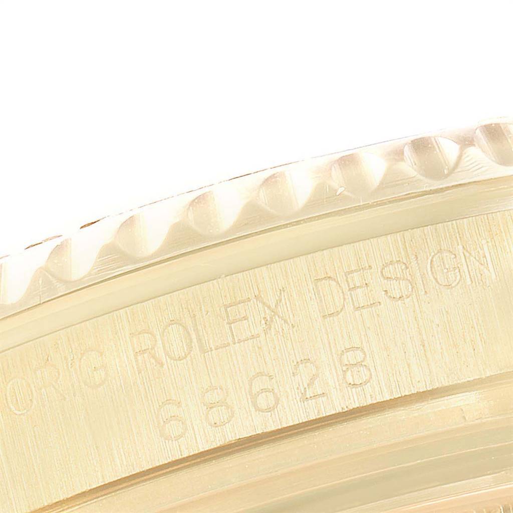 The image shows a close-up of the bezel and part of the case of a Rolex Yacht-Master 68628 Yellow Gold Blue Dial 68628 Yellow Gold Blue Dial watch, with the model number and "ROLEX DESIGN" visible.