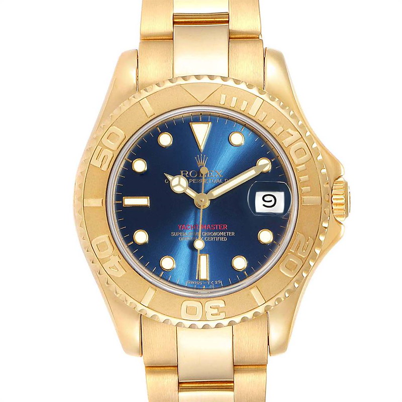 The image shows a front view of the Rolex Yacht-Master watch, featuring a gold case, blue dial, and gold bracelet.