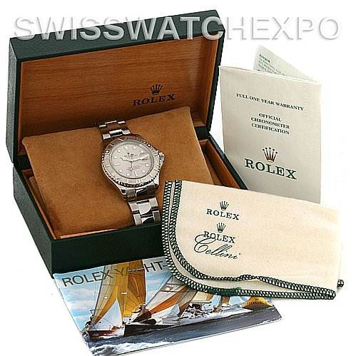 The image shows a Rolex Yacht-Master 16622 Men's Stainless Steel Silver Dial 16622 Men's Stainless Steel Silver Dial watch with its box, warranty card, manual, and a polishing cloth.