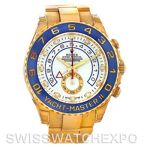 The image shows a frontal view of a Rolex Yacht-Master 116688WAO Men's Yellow Gold White Dial 116688WAO Men's Yellow Gold White Dial II watch, highlighting its gold case, blue bezel, and white dial with various markers.