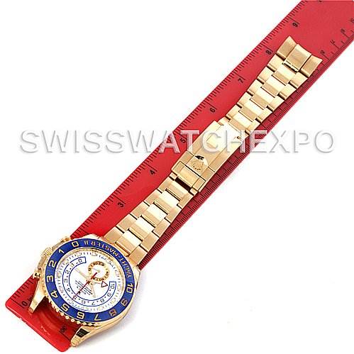 The image shows a top-down view of a Rolex Yacht-Master 116688WAO Men's Yellow Gold White Dial 116688WAO Men's Yellow Gold White Dial watch laid flat next to a red ruler.