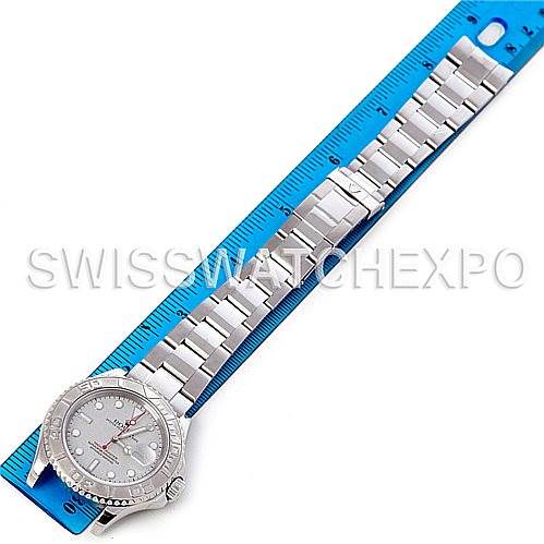 The Rolex Yacht-Master 16622 Men's Stainless Steel Silver Dial 16622 Men's Stainless Steel Silver Dial watch is shown from above, with its band extended next to a blue ruler.