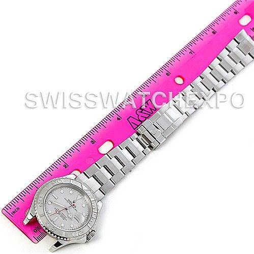 The Rolex Yacht-Master 16622 Men's Stainless Steel Silver Dial 16622 Men's Stainless Steel Silver Dial watch is shown at a top-down angle, displaying the face, bezel, and bracelet, alongside a pink ruler for scale.