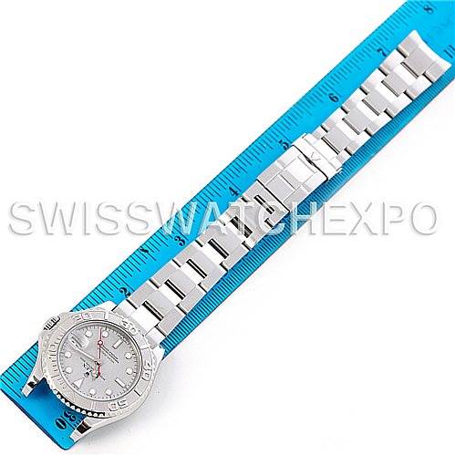 The Rolex Yacht-Master 168622 Stainless Steel Silver Dial 168622 Stainless Steel Silver Dial watch is shown from an overhead angle, highlighting its face and entire metal bracelet, placed next to a ruler.