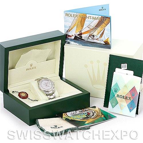 The image shows a Yacht-Master model by Rolex in its box, along with brochures, tags, and protective cloths.