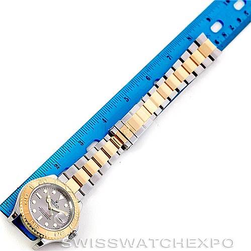 The image shows a Rolex Yacht-Master 16623 Men's Stainless Steel Grey Dial 16623 Men's Stainless Steel Grey Dial watch positioned next to a blue ruler, displaying its case, bezel, dial, bracelet, and clasp.