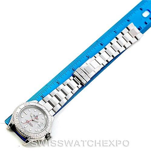 The image shows a top-down view of a Rolex Yacht-Master 16622 Men's Stainless Steel Silver Dial 16622 Men's Stainless Steel Silver Dial watch alongside a blue ruler for scale.