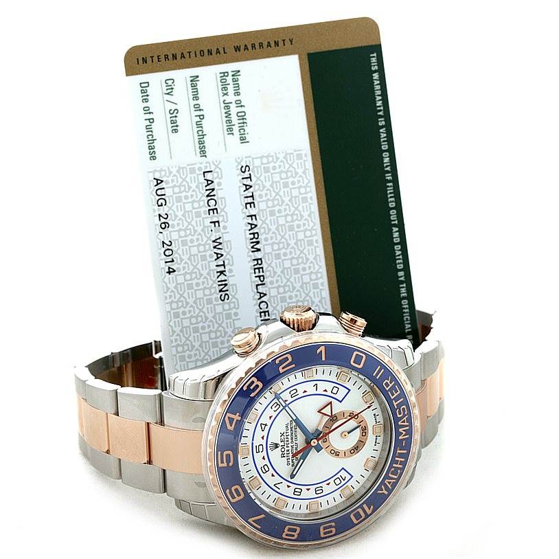 The image shows a Rolex Yacht-Master 116681 Men's Steel and Gold (two tone) White Dial 116681 Men's Steel and Gold (two tone) White Dial watch at an angle displaying the face, crown, buttons, and bracelet, alongside its warranty card.
