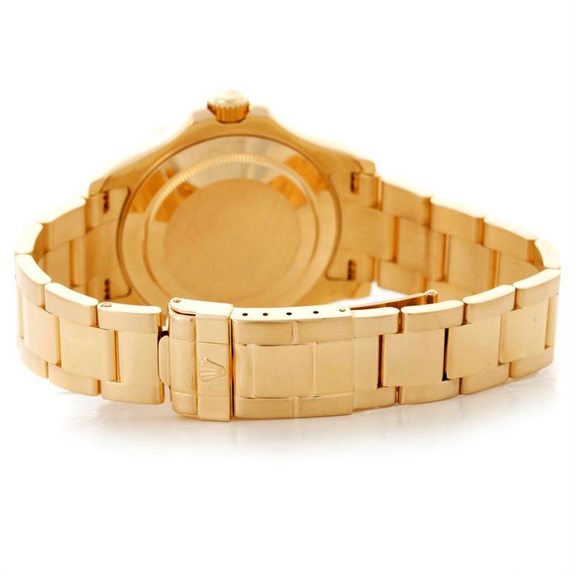 The image shows the underside and clasp area of a Rolex Yacht-Master 16628 Men's Yellow Gold White Dial 16628 Men's Yellow Gold White Dial watch from a slightly elevated rear angle.