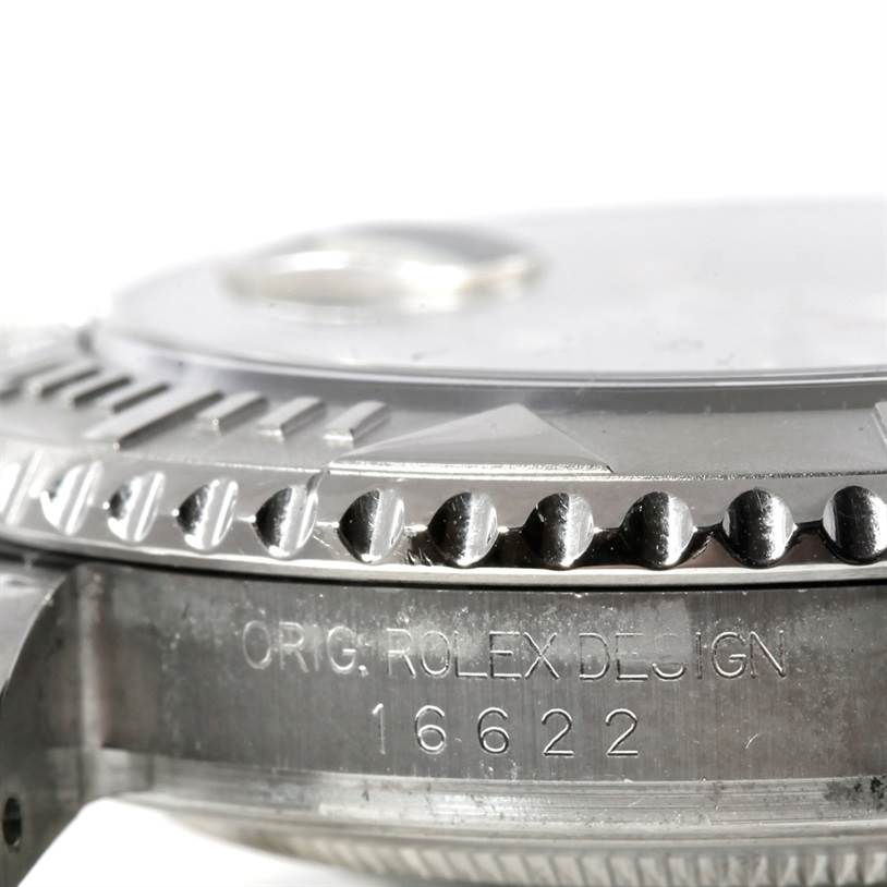 This close-up image shows the engraved bezel and part of the case of a Rolex Yacht-Master 16622 Men's Stainless Steel Silver Dial 16622 Men's Stainless Steel Silver Dial model.