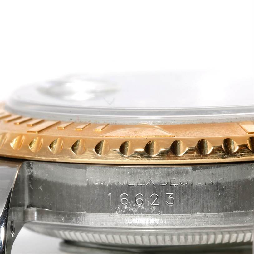 The image shows a close-up side view of the bezel, crystal, and case of a Rolex Yacht-Master 16623 Men's Stainless Steel Grey Dial 16623 Men's Stainless Steel Grey Dial watch with its model number engraved.