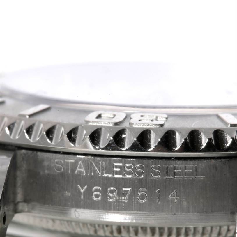 This close-up image of a Rolex Yacht-Master 168622 Stainless Steel Silver Dial 168622 Stainless Steel Silver Dial watch shows part of the bezel and case with serial and material engraving.
