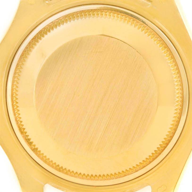 The image shows a close-up of the back case of a Rolex Yacht-Master 68628 Men
s Yellow Gold Blue Dial 68628 Men
s Yellow Gold Blue Dial watch, primarily showcasing the gold finish and textured edge.