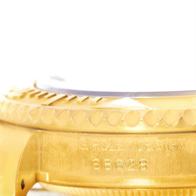 This close-up image shows the side view of a Rolex Yacht-Master 68628 Men
s Yellow Gold Blue Dial 68628 Men
s Yellow Gold Blue Dial watch, focusing on the bezel and engraved case details.