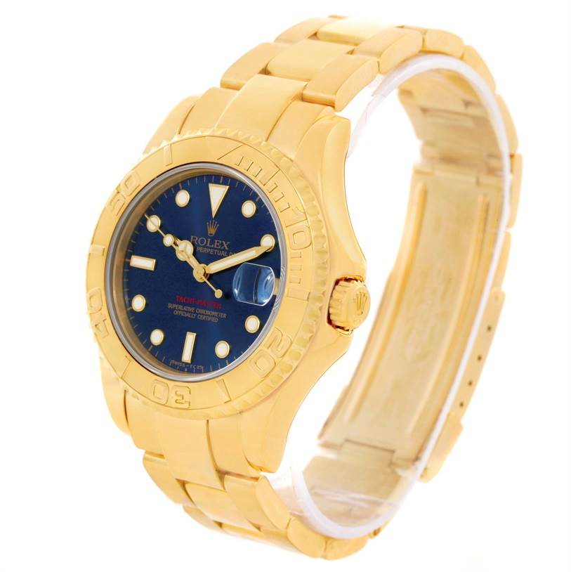 The Rolex Yacht-Master 68628 Men
s Yellow Gold Blue Dial 68628 Men
s Yellow Gold Blue Dial watch is shown at a front-left angle, highlighting its gold case, blue dial, and bracelet.
