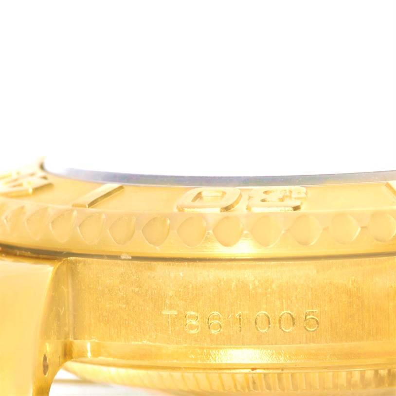 The image shows a close-up of the gold bezel and case of a Rolex Yacht-Master 68628 Men
s Yellow Gold Blue Dial 68628 Men
s Yellow Gold Blue Dial watch, including the serial number.