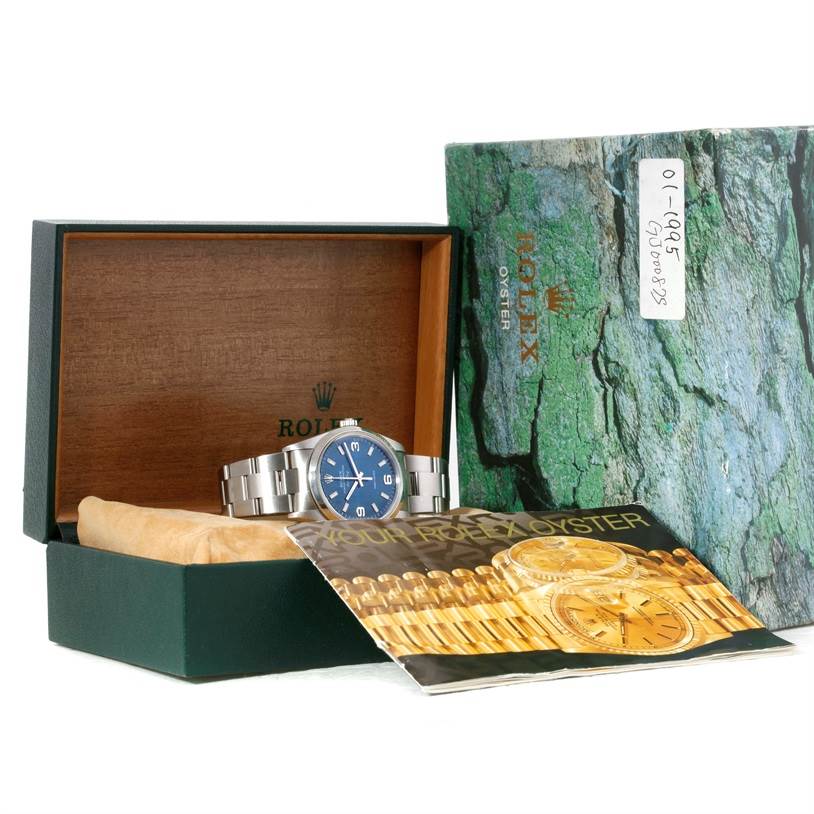 The image shows a Rolex Air-King 14000 Men's Stainless Steel Blue Dial 14000 Men's Stainless Steel Blue Dial watch displayed inside its box along with its booklet.