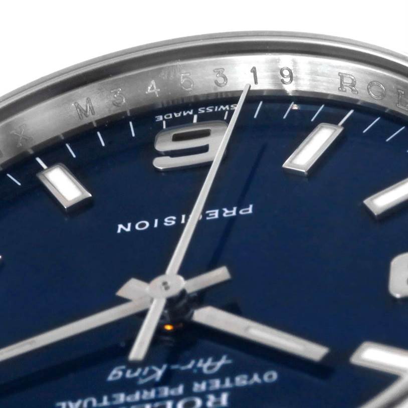 The image shows a close-up angle of the dial, hands, and part of the bezel of the Rolex Air-King 114200 Men's Stainless Steel Blue Dial 114200 Men's Stainless Steel Blue Dial watch.