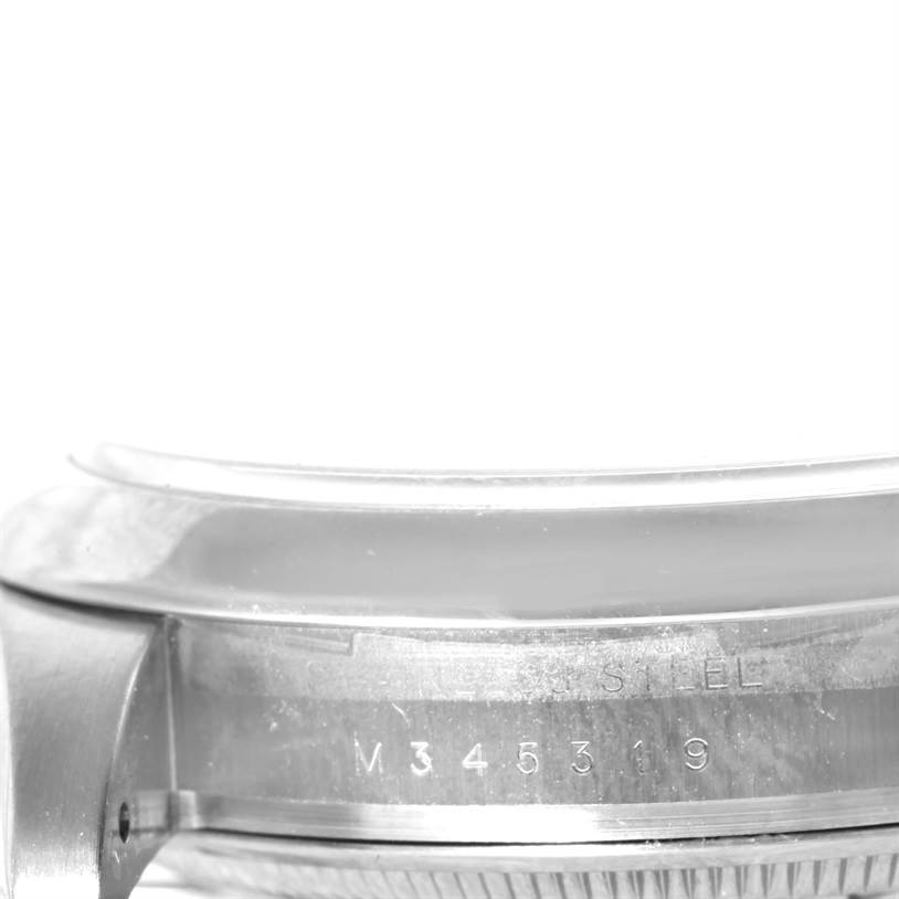 This image shows a close-up view of the side case and serial number of a Rolex Air-King 114200 Men's Stainless Steel Blue Dial 114200 Men's Stainless Steel Blue Dial watch.