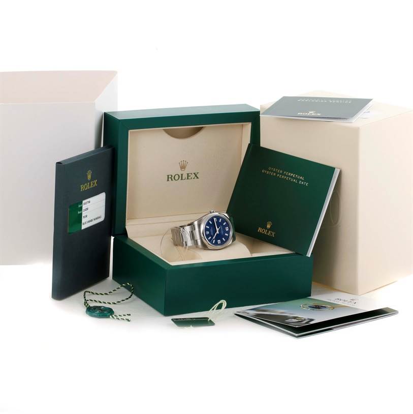 The image shows a Rolex Air-King 114200 Men's Stainless Steel Blue Dial 114200 Men's Stainless Steel Blue Dial watch in its box with accompanying booklets and accessories from a front angle.