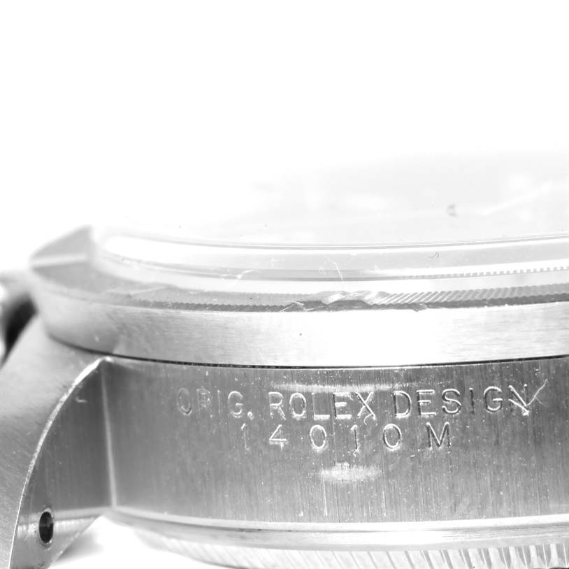 This image shows a close-up of the side of a Rolex Air-King 14010 Men's Stainless Steel Blue Dial 14010 Men's Stainless Steel Blue Dial watch case, displaying the serial number and "ROLEX DESIGN" engraving.