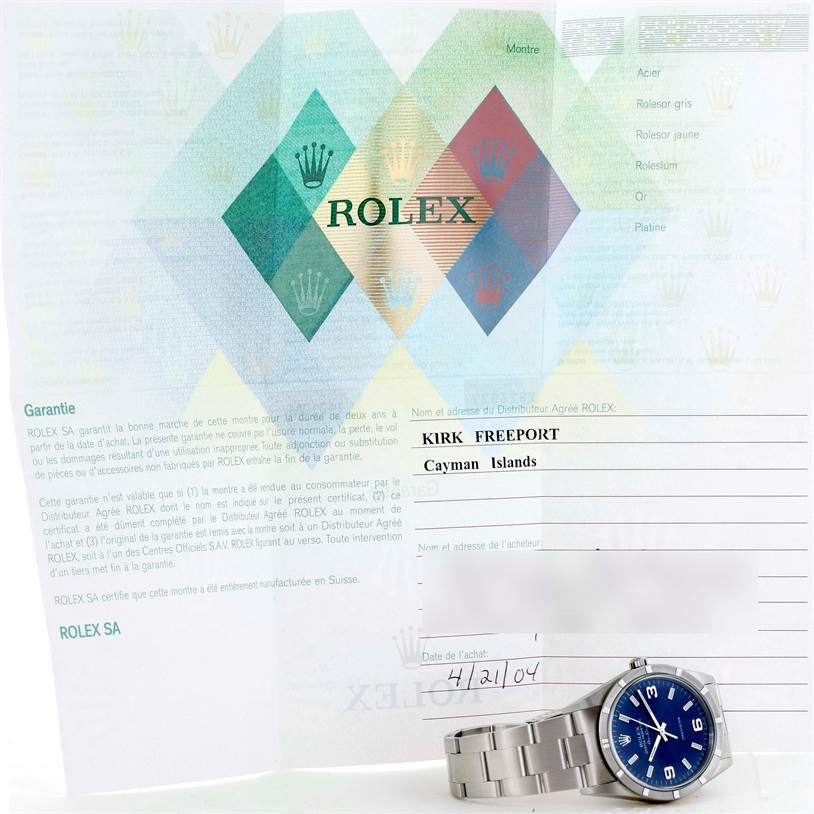 The image shows a Rolex Air-King 14010 Men's Stainless Steel Blue Dial 14010 Men's Stainless Steel Blue Dial watch placed at an angle, with warranty documents in the background.