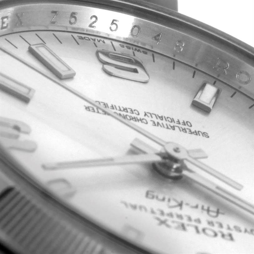 The image shows a close-up angle of the Rolex Air-King 114210 Men's Stainless Steel Silver Dial 114210 Men's Stainless Steel Silver Dial watch, highlighting its dial, hands, and part of the bezel.