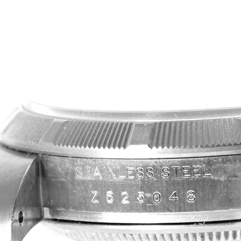 This image shows a close-up side view of the bezel and case of a Rolex Air-King 114210 Men's Stainless Steel Silver Dial 114210 Men's Stainless Steel Silver Dial watch, displaying its stainless steel construction and serial number.