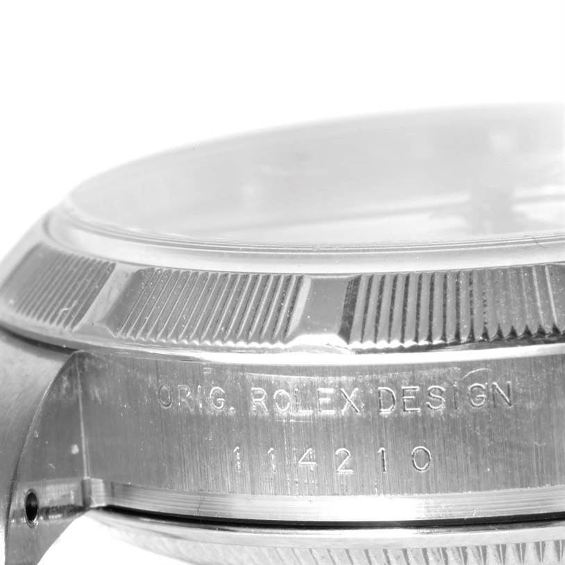 This is a close-up side view of the Rolex Air-King 114210 Men's Stainless Steel Silver Dial 114210 Men's Stainless Steel Silver Dial watch, showing the bezel and engraved model number.