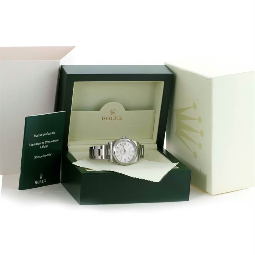 The image shows a Rolex Air-King 114200 Men's Stainless Steel Silver Dial 114200 Men's Stainless Steel Silver Dial watch inside its open green box, along with a manual and white protective cloth.