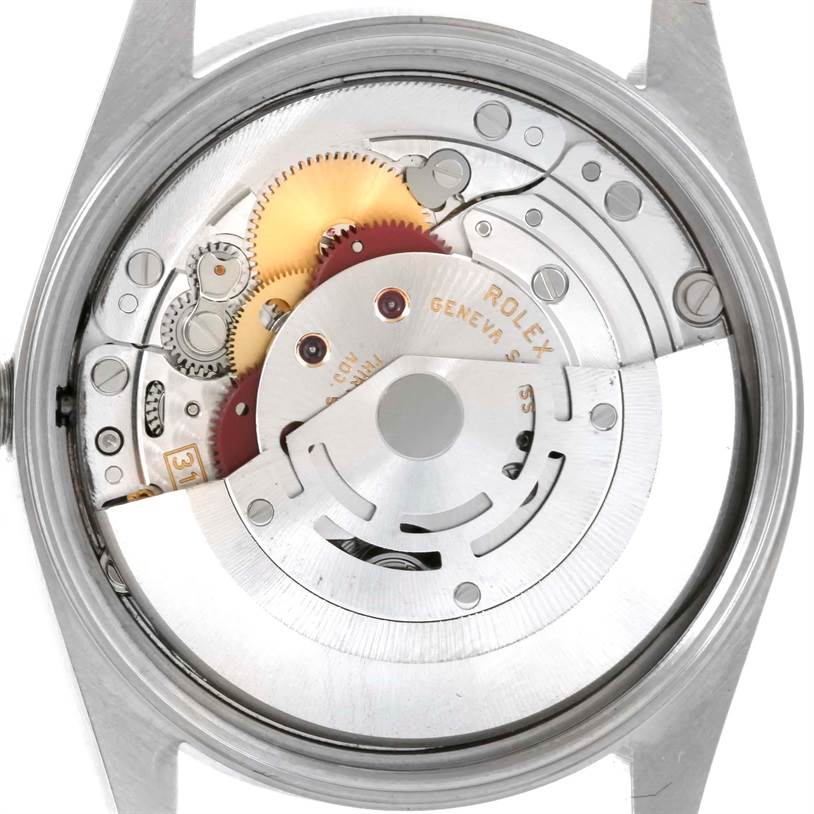 This is a close-up view of the inner mechanics of a Rolex Air-King 14010 Men's Stainless Steel Silver Dial 14010 Men's Stainless Steel Silver Dial watch, showcasing the movement and gears.
