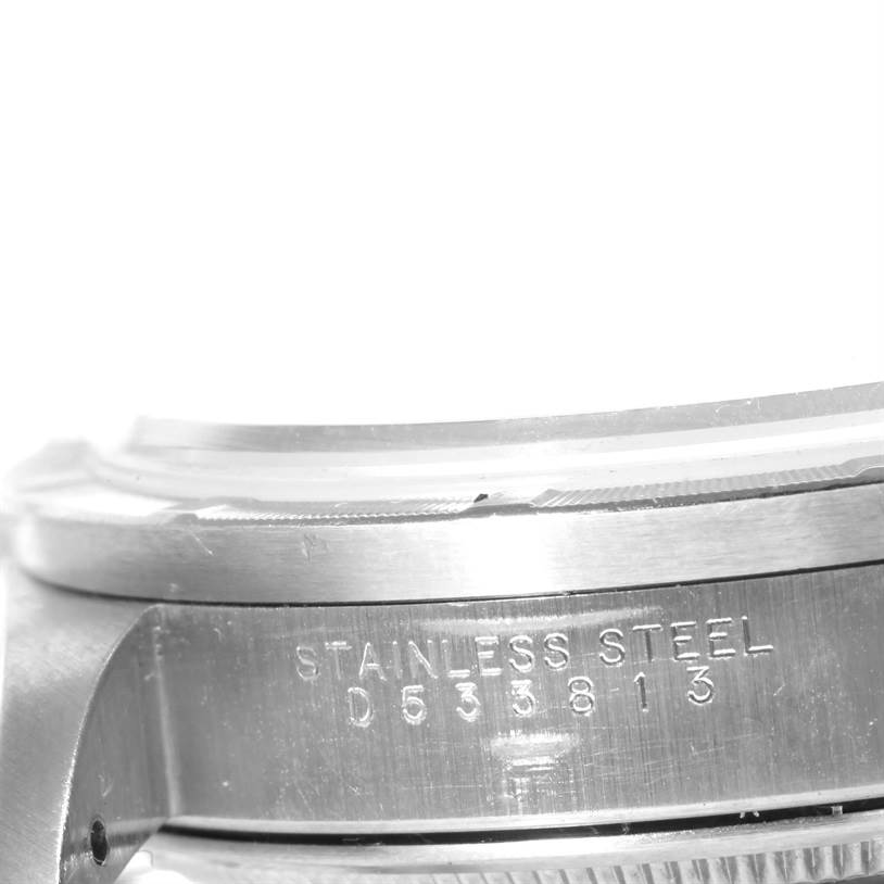 This image displays a close-up side view of the case of a Rolex Air-King 14010 Men's Stainless Steel Silver Dial 14010 Men's Stainless Steel Silver Dial watch, highlighting the serial number and "STAINLESS STEEL" engraving.
