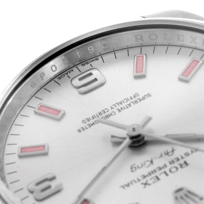 The close-up image of the Rolex Air-King 114200 Men's Stainless Steel Silver Dial 114200 Men's Stainless Steel Silver Dial watch shows the dial, hands, and the etched inner bezel with a partial view of the case.