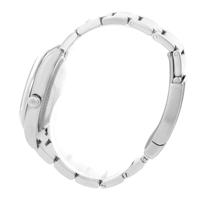 The image shows a side view of a Rolex Air-King 114200 Men's Stainless Steel Silver Dial 114200 Men's Stainless Steel Silver Dial watch, highlighting its crown and metal bracelet.