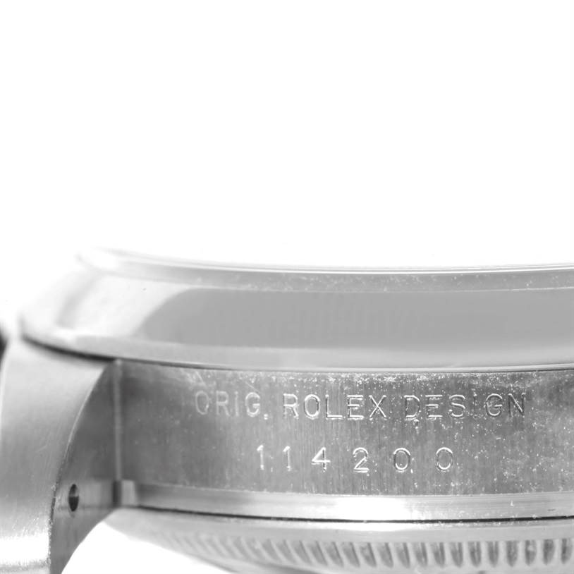 The image shows a close-up view of the case side of a Rolex Air-King 114200 Men's Stainless Steel Silver Dial 114200 Men's Stainless Steel Silver Dial watch, displaying the engraved model number.