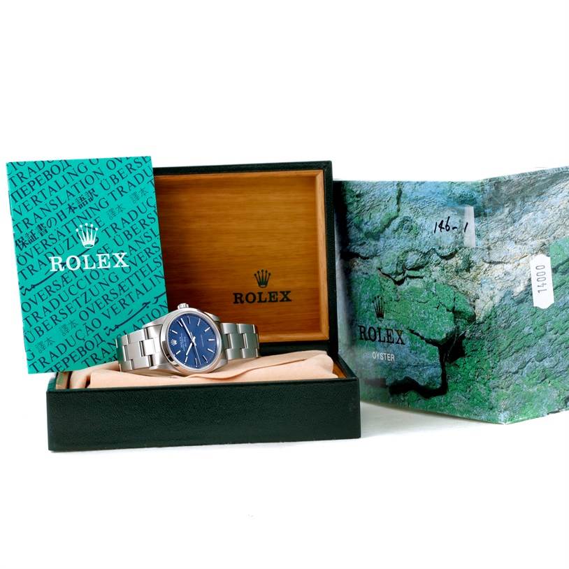 The image shows a Rolex Air-King 14000 Men's Stainless Steel Blue Dial 14000 Men's Stainless Steel Blue Dial watch in its box, with its blue dial visible, and accompanied by Rolex documentation and packaging.