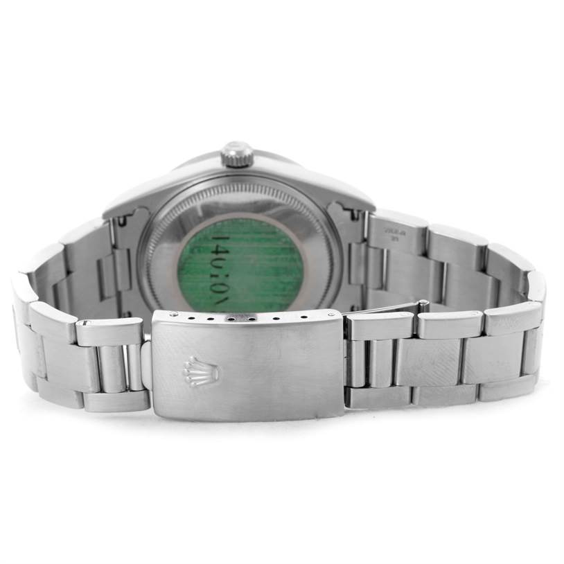 The image shows the back and bracelet of a Rolex Air-King 14010 Men's Stainless Steel Silver Dial 14010 Men's Stainless Steel Silver Dial watch, featuring the clasp and the case back with its green sticker.