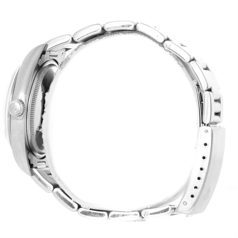 This side view of the Rolex Air-King 14000 Men's Stainless Steel Pink Dial 14000 Men's Stainless Steel Pink Dial watch displays its stainless steel case and bracelet clasp.