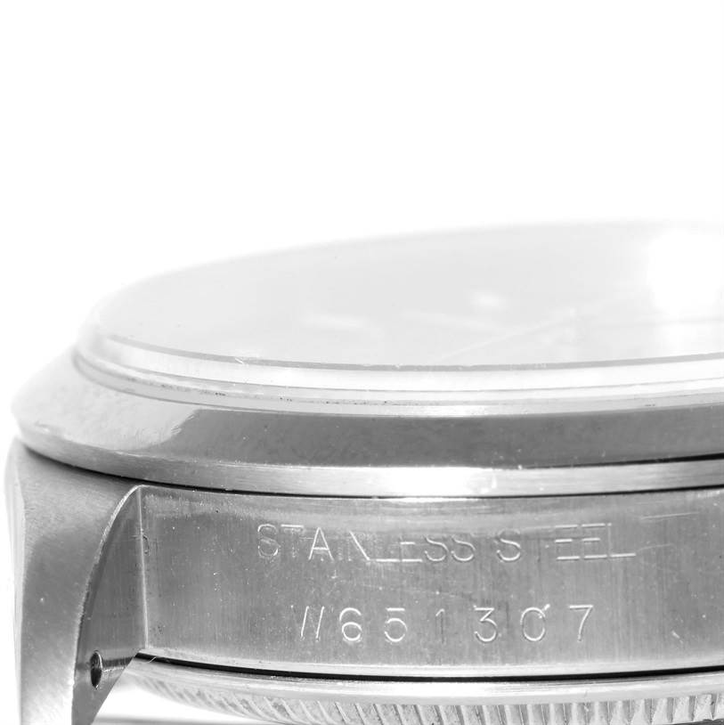 The image shows a side view of the Rolex Air-King 14000 Men's Stainless Steel Pink Dial 14000 Men's Stainless Steel Pink Dial watch, focusing on its stainless steel case with visible engravings.