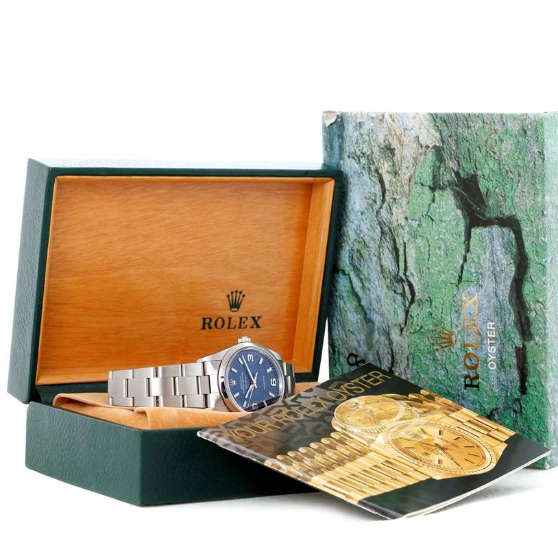 The image shows a Rolex Air-King 14000 Men's Stainless Steel Blue Dial 14000 Men's Stainless Steel Blue Dial watch in its open box, angled to highlight the watch face, with accompanying booklet.