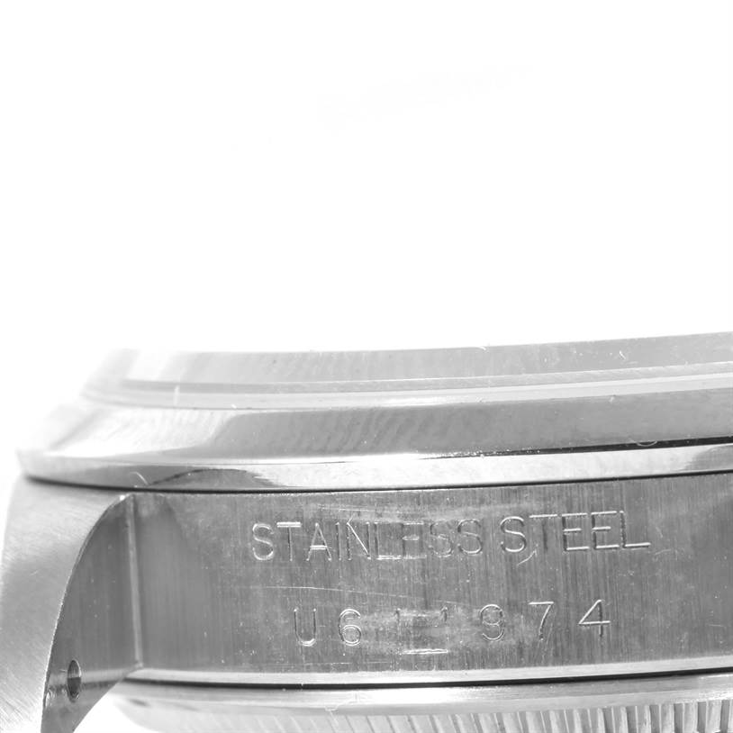 The image shows a side view of the case of a Rolex Air-King 14000 Men's Stainless Steel Black Dial 14000 Men's Stainless Steel Black Dial watch, highlighting the stainless steel and serial number.